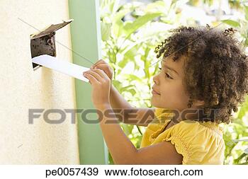 Stock Photograph - girl putting mail 
through a mail 
slot in door. 
fotosearch - search 
stock photos, 
pictures, images, 
and photo clipart