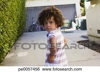 Stock Photo - girl standing 
in driveway looking 
back over shoulder. 
fotosearch - search 
stock photos, 
pictures, images, 
and photo clipart