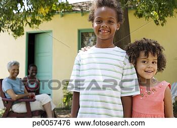 Stock Photo - two children outdoors 
with two women 
in background. 
fotosearch - search 
stock photos, 
pictures, images, 
and photo clipart