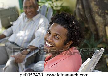 Stock Photo - two men sitting 
outdoors relaxing. 
fotosearch - search 
stock photos, 
pictures, images, 
and photo clipart