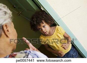 Stock Photography - woman scolding 
young girl in 
doorway. fotosearch 
- search stock 
photos, pictures, 
images, and photo 
clipart