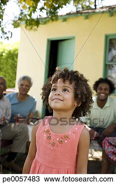 Stock Photo - young girl outdoors 
looking up with 
people in background. 
fotosearch - search 
stock photos, 
pictures, images, 
and photo clipart