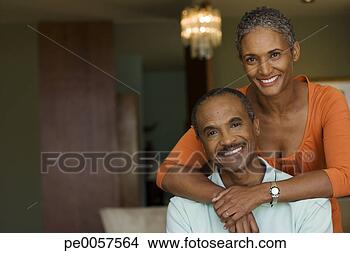 Stock Photo - couple in living 
room smiling. 
fotosearch - search 
stock photos, 
pictures, images, 
and photo clipart