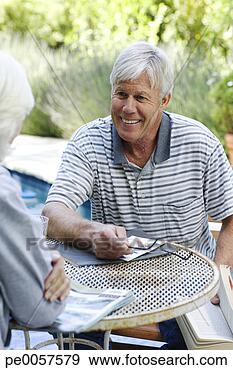 Stock Photograph - couple sitting 
at patio table 
outdoors. fotosearch 
- search stock 
photos, pictures, 
images, and photo 
clipart