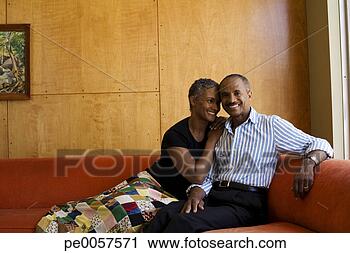 Stock Photography - couple on sofa 
in modern home. 
fotosearch - search 
stock photos, 
pictures, images, 
and photo clipart
