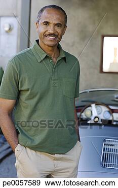 Stock Photograph - man standing behind 
parked convertible 
car. fotosearch 
- search stock 
photos, pictures, 
images, and photo 
clipart