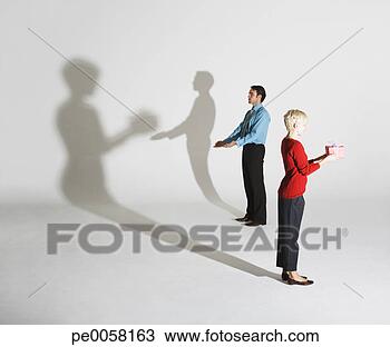 Stock Photo - businessman and 
woman standing 
so shadows look 
like she's giving 
him. fotosearch 
- search stock 
photos, pictures, 
images, and photo 
clipart