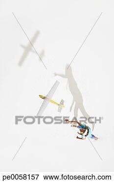 Picture - girl playing with 
a toy plane. fotosearch 
- search stock 
photos, pictures, 
images, and photo 
clipart
