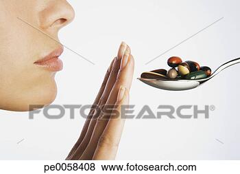 Stock Photo - woman with hand 
blocking spoonful 
of pills. fotosearch 
- search stock 
photos, pictures, 
images, and photo 
clipart