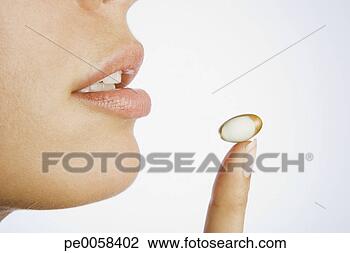 Stock Photo - woman with pill 
on finger. fotosearch 
- search stock 
photos, pictures, 
images, and photo 
clipart
