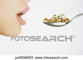 Stock Photo - woman taking a 
spoonful of pills. 
fotosearch - search 
stock photos, 
pictures, images, 
and photo clipart