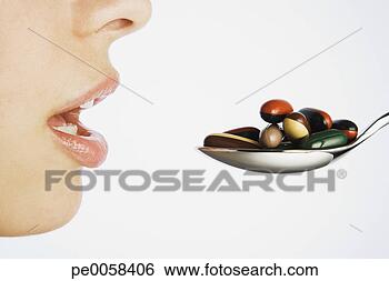 Stock Photo - woman taking a 
spoonful of pills. 
fotosearch - search 
stock photos, 
pictures, images, 
and photo clipart