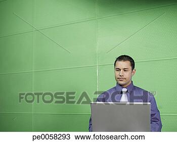 Stock Photo - businessman with 
laptop in green 
office. fotosearch 
- search stock 
photos, pictures, 
images, and photo 
clipart