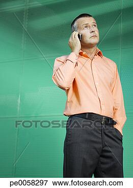 Picture - businessman on 
mobile phone in 
green office. 
fotosearch - search 
stock photos, 
pictures, images, 
and photo clipart