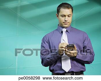 Stock Photo - businessman using 
pda in blue office. 
fotosearch - search 
stock photos, 
pictures, images, 
and photo clipart