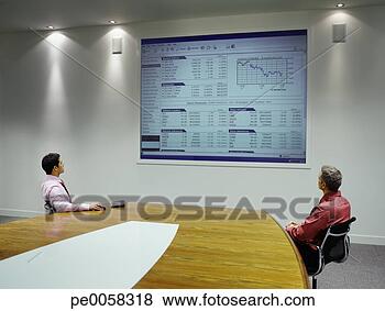 Stock Photo - businesspeople 
watching presentation 
on projection 
screen. fotosearch 
- search stock 
photos, pictures, 
images, and photo 
clipart