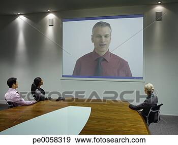 Stock Photograph - businesspeople 
watching presentation 
on projection 
screen. fotosearch 
- search stock 
photos, pictures, 
images, and photo 
clipart