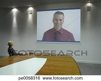 Stock Photo - businesswoman 
watching presentation 
on projection 
screen. fotosearch 
- search stock 
photos, pictures, 
images, and photo 
clipart