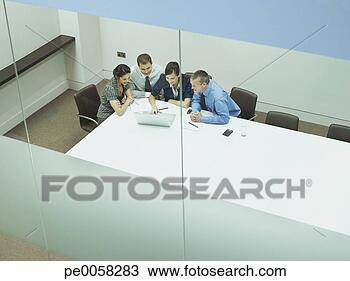 Stock Photo - four businesspeople 
at a table with 
documents and 
laptop. fotosearch 
- search stock 
photos, pictures, 
images, and photo 
clipart