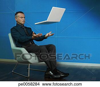 Stock Photo - man sitting with 
laptop floating 
over his lap. 
fotosearch - search 
stock photos, 
pictures, images, 
and photo clipart