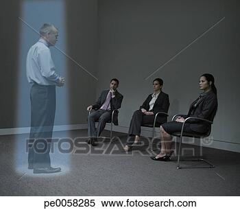 Stock Image - three businesspeople 
watching a hologram 
of a businessman. 
fotosearch - search 
stock photos, 
pictures, images, 
and photo clipart
