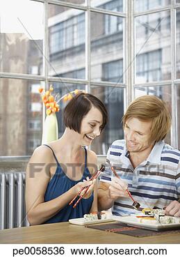 Stock Photo - couple eating 
sushi in modern 
home. fotosearch 
- search stock 
photos, pictures, 
images, and photo 
clipart