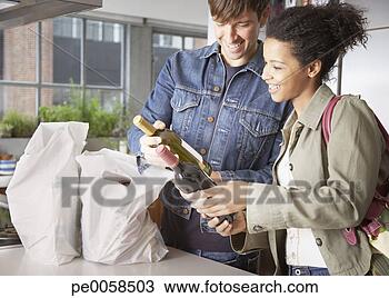 Stock Photo - couple with groceries 
and wine in kitchen. 
fotosearch - search 
stock photos, 
pictures, images, 
and photo clipart