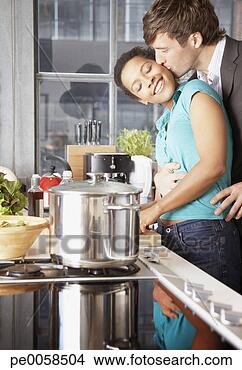 Stock Photo - couple kissing 
and embracing 
in kitchen. fotosearch 
- search stock 
photos, pictures, 
images, and photo 
clipart