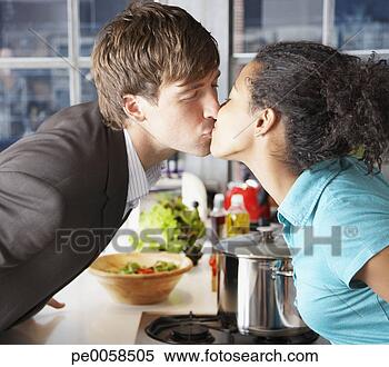 Stock Image - couple kissing 
in kitchen over 
counter. fotosearch 
- search stock 
photos, pictures, 
images, and photo 
clipart