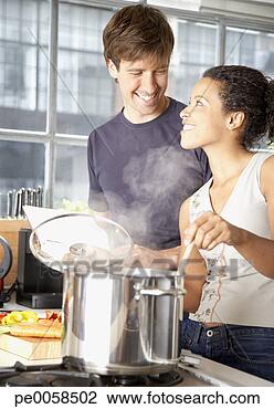 Stock Photo - couple making 
meal in kitchen. 
fotosearch - search 
stock photos, 
pictures, images, 
and photo clipart