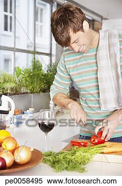 Stock Image - man cutting red 
peppers in a kitchen. 
fotosearch - search 
stock photos, 
pictures, images, 
and photo clipart
