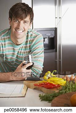 Stock Photo - man with a glass 
of wine and chopped 
peppers beside 
him. fotosearch 
- search stock 
photos, pictures, 
images, and photo 
clipart