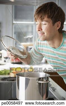 Picture - man smelling aroma 
from cooking pot. 
fotosearch - search 
stock photos, 
pictures, images, 
and photo clipart