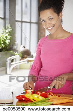 Stock Photography - woman cutting 
peppers in a kitchen. 
fotosearch - search 
stock photos, 
pictures, images, 
and photo clipart