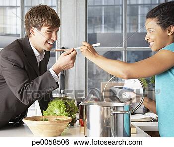 Stock Photo - woman feeding 
man with a spoon. 
fotosearch - search 
stock photos, 
pictures, images, 
and photo clipart