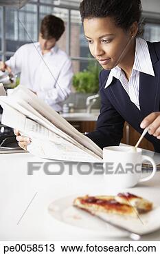 Stock Photo - woman with toast 
and man in background 
pouring coffee. 
fotosearch - search 
stock photos, 
pictures, images, 
and photo clipart