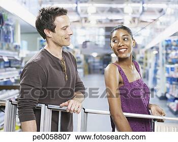 Picture - couple carrying 
ladder through 
store. fotosearch 
- search stock 
photos, pictures, 
images, and photo 
clipart