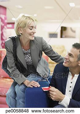 Stock Photo - couple looking 
at couches in 
store. fotosearch 
- search stock 
photos, pictures, 
images, and photo 
clipart