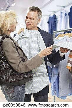Stock Photo - couple shopping 
for shirts in 
store. fotosearch 
- search stock 
photos, pictures, 
images, and photo 
clipart