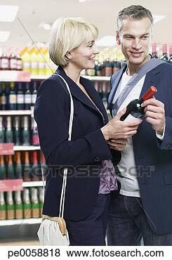 Stock Photo - couple shopping 
for wine. fotosearch 
- search stock 
photos, pictures, 
images, and photo 
clipart