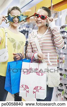 Stock Photography - girls trying on 
sunglasses in 
store. fotosearch 
- search stock 
photos, pictures, 
images, and photo 
clipart