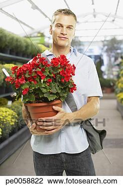 Stock Photo - man holding potted 
plant. fotosearch 
- search stock 
photos, pictures, 
images, and photo 
clipart
