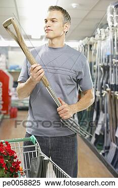 Stock Image - man looking at 
pitchfork in store. 
fotosearch - search 
stock photos, 
pictures, images, 
and photo clipart