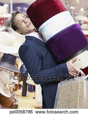Stock Photo - man in store with 
hat boxes and 
shopping bags. 
fotosearch - search 
stock photos, 
pictures, images, 
and photo clipart