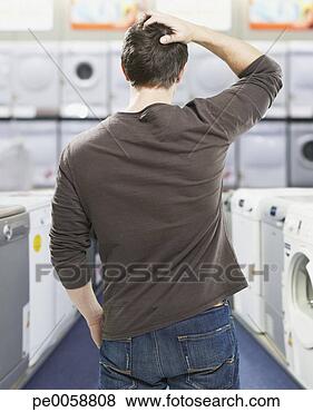 Stock Photo - man in store looking 
at appliances 
confused. fotosearch 
- search stock 
photos, pictures, 
images, and photo 
clipart