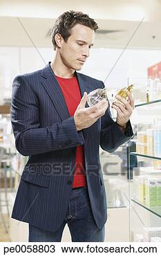 Stock Photo - man testing cologne 
in store. fotosearch 
- search stock 
photos, pictures, 
images, and photo 
clipart