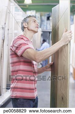 Stock Photograph - man with wood 
in store. fotosearch 
- search stock 
photos, pictures, 
images, and photo 
clipart