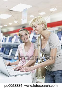 Stock Photo - woman and girl 
on laptop in store. 
fotosearch - search 
stock photos, 
pictures, images, 
and photo clipart