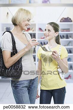 Stock Photo - woman and girl 
looking at shoes 
in store. fotosearch 
- search stock 
photos, pictures, 
images, and photo 
clipart