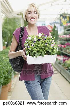 Stock Photography - woman holding 
plants. fotosearch 
- search stock 
photos, pictures, 
images, and photo 
clipart
